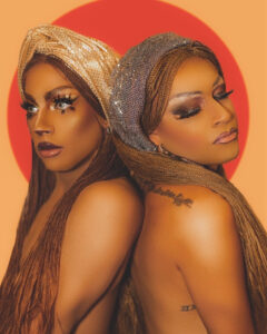 Avery Martini and Dyonne Dahl in glam drag makeup, posing back to back